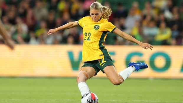 Charli Grant of the Matildas crosses the ball.