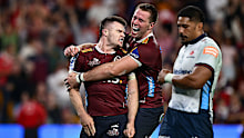 Isaac Henry of the Reds celebrates after scoring a try.