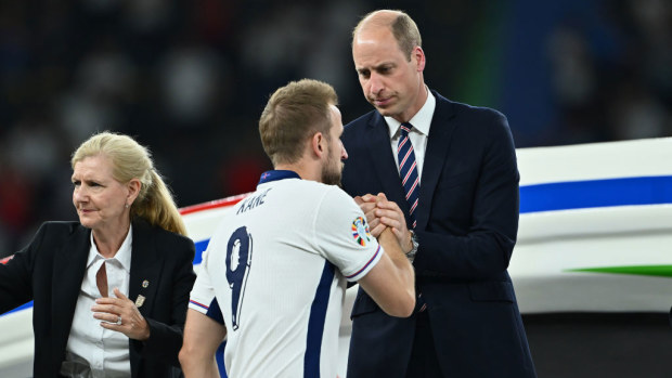 Harry Kane shakes hands with Prince William, Prince of Wales and President of The FA, as he collects his Runners Up Medal.