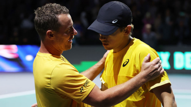 Lleyton Hewitt embraces Alex De Minaur of Australia.