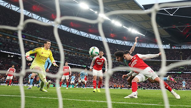 Nico O'Reilly of Manchester City scores under pressure from Martin Zubimendi of Arsenal.