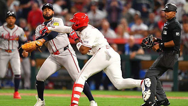 Los Angeles Angels designated hitter Jorge Soler swings a punch at Atlanta Braves pitcher Reynaldo Lopez.