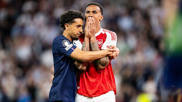 Marquinhos of Paris Saint-Germain comforts Gabriel of Arsenal.