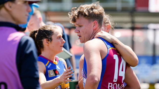 Dakota Davidson of the Lions is seen being consoled by teammates. Brisbane Lions v St Kilda Saints