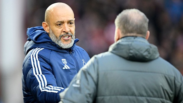Nuno Espirito Santo interacts with Ange Postecoglou.