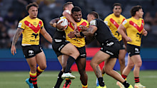 Sylvester Namo of Papua New Guinea is tackled.