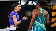Sorana Cirstea of Romania argues with Naomi Osaka of Japan at the net.
