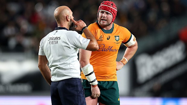Referee Andrea Piardi talks with Harry Wilson of Australia.