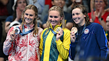 (L-R) Summer McIntosh, Ariarne Titmus and Katie Ledecky with their medals after the 400m Olympic final. 