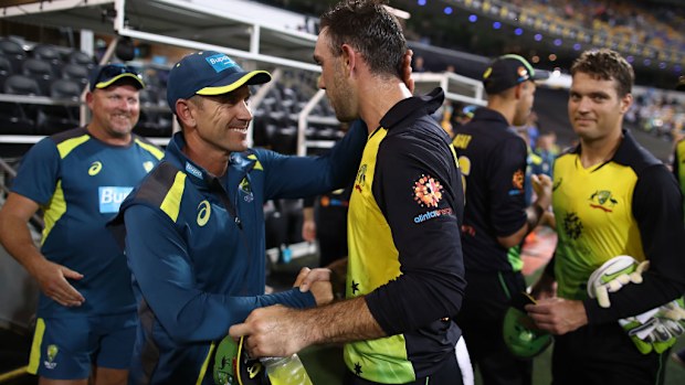 Justin Langer, coach of Australia,  and Glenn Maxwell of Australia celebrate after game one of the the International Twenty20 series between Australia and India.