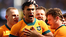 Joseph-Aukuso Suaalii of the Wallabies celebrates with teammates after scoring a try.