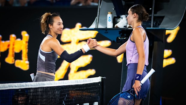 Qinwen Zheng of China and Anca Todoni of Romania shake hands at the net.