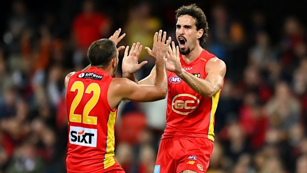 Ben King of the Suns celebrates kicking a goal.