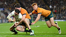 Alex Mitchell of England breaks through the tackles of Nick Frost and Tane Edmed.