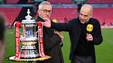 Gary Lineker speaks to Pep Guardiola with the FA Cup trophy.