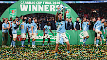 Nico O'Reilly of Manchester City celebrates with the trophy.