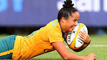 Nicole Ledington of the Wallaroos scores a try.