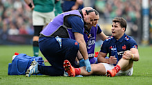 Antoine Dupont of France reacts as he receives medical treatment.
