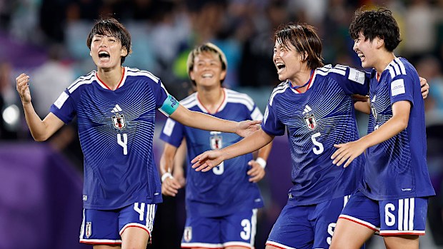 Saki Kumagai, Hana Takahashi and Toko Koga of Japan celebrate winning.