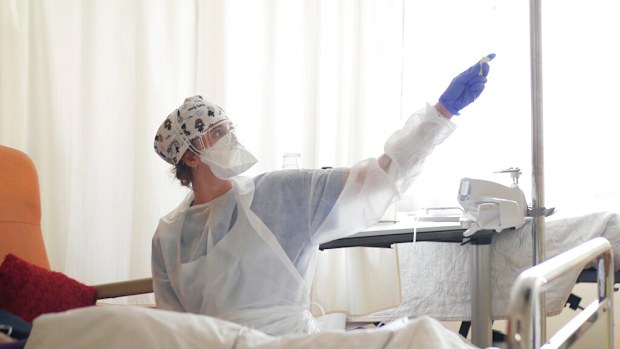 In this March 19, 2021, file photo, a nurse tends to a patient affected by COVID-19 virus in the ICU unit at the Ambroise Pare clinic in Neuilly-sur-Seine.