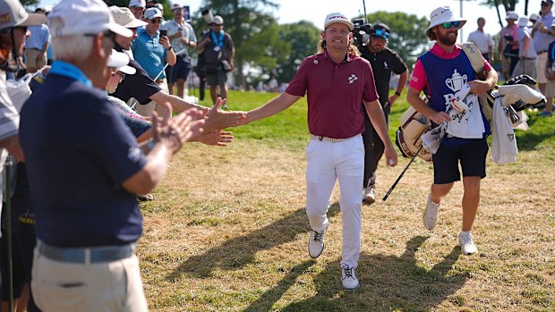 Cameron Smith high fives spectators on his walk towards the 16th hole tee box.