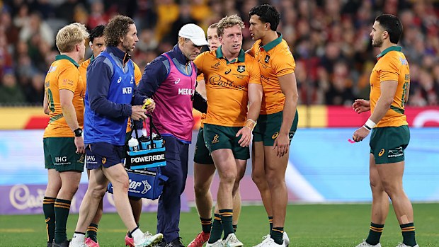 Harry Potter of the Wallabies is assisted from the field.