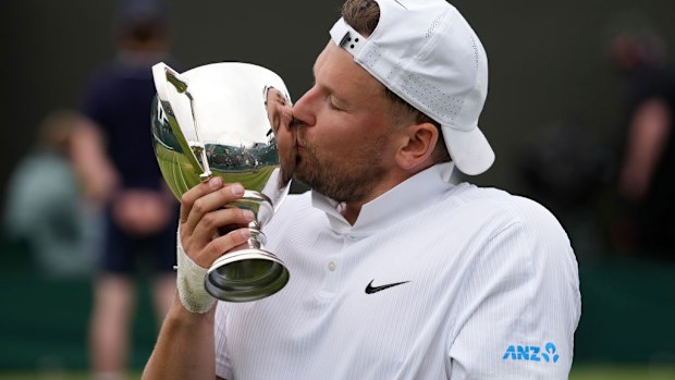 Dylan Alcott of Australia celebrates with the trophy at Wimbledon.
