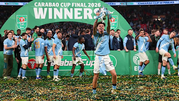 Nico O'Reilly of Manchester City celebrates with the trophy.