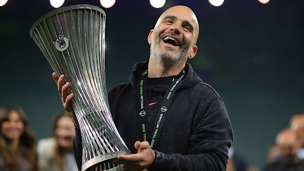 Enzo Maresca, the manager of Chelsea, lifts the UEFA Conference League trophy.