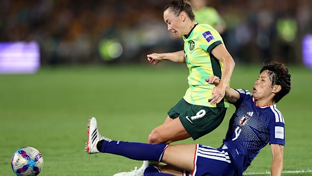 Caitlin Foord of the Matildas is challenged by Saki Kumagai of Japan.