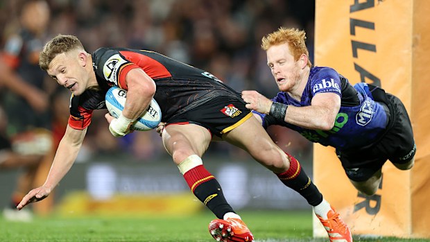Finlay Christie of the Blues tackles Damian McKenzie of the Chiefs.