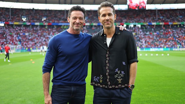 Hugh Jackman ve Ryan Reynolds maç öncesi atmosferin tadını çıkarıyor.