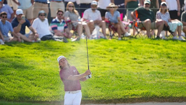 Cameron Smith hits out of the bunker for his third shot.