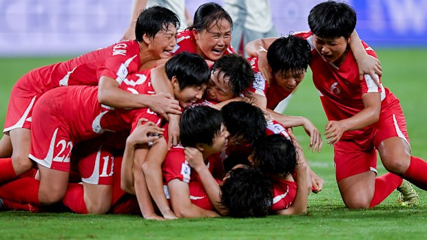 Players of DPR Korea celebrate their teammate Choe Il-Son's goal before it is cancelled by a VAR check.