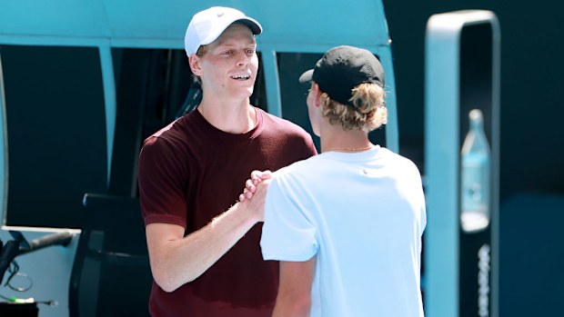 Jannik Sinner of Italy and Cruz Hewitt of Australia shake hands following a practice session.