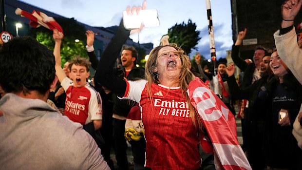Fans celebrate as Arsenal are confirmed as Premier League champions.
