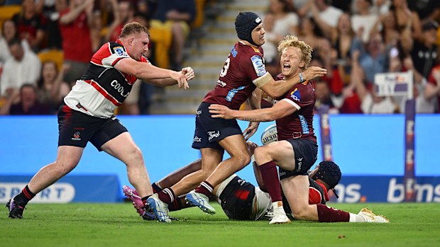 Carter Gordon of the Reds celebrates with team mates after scoring a try during the round nine Super Rugby match.