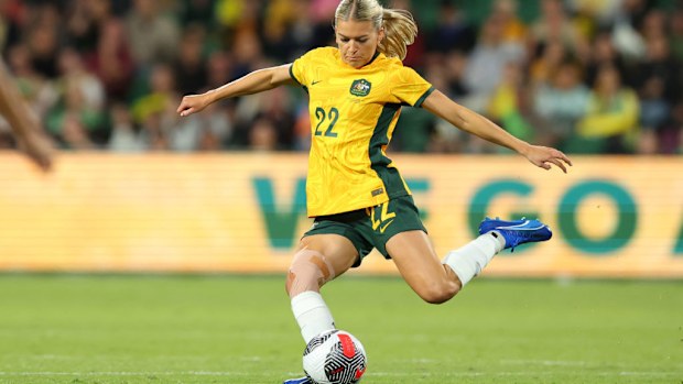 Charli Grant of the Matildas crosses the ball.