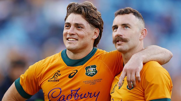 James O'Connor and Nic White of the Wallabies look on.