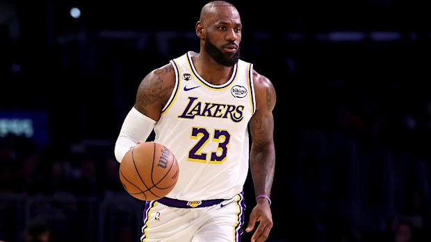 LeBron James brings the ball up court.