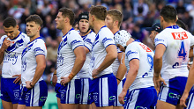 Bulldogs look on after another Knights try. 