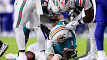 Tua Tagovailoa of the Miami Dolphins lays on the ground.