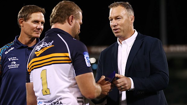 James Slipper of the Brumbies is presented a trophy by Wyatt Crockett.