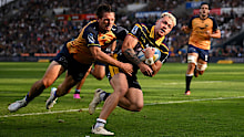 Caleb Tangitau of the Highlanders charges across the try line to score.