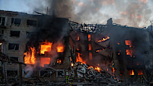 Rescue workers try to put out a fire at a residential building after a Russian strike on Kyiv, Ukraine, on Sunday, May 24, 2026.