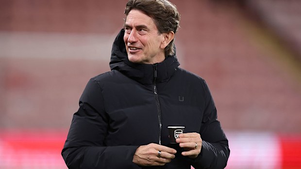 Thomas Frank holding a cup with the Arsenal club badge on.