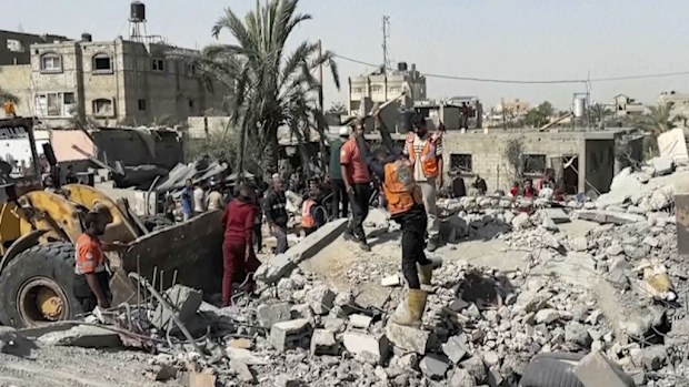 Palestinians check a building destroyed by Israeli airstrikes in the city of Khan Younis, southern Gaza Strip, Friday, Oct. 25, 2024. (AP Photo)