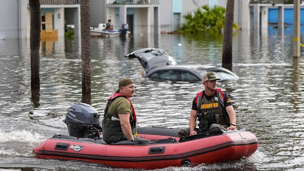 A water rescue boat moves in flood waters at an apartment complex in the aftermath of Hurricane Milton, Thursday, Oct. 10, 2024, in Clearwater, Fla. (AP Photo/Mike Stewart)