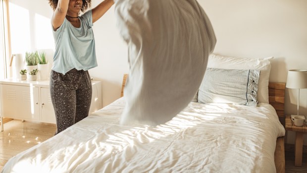 A woman making her bed