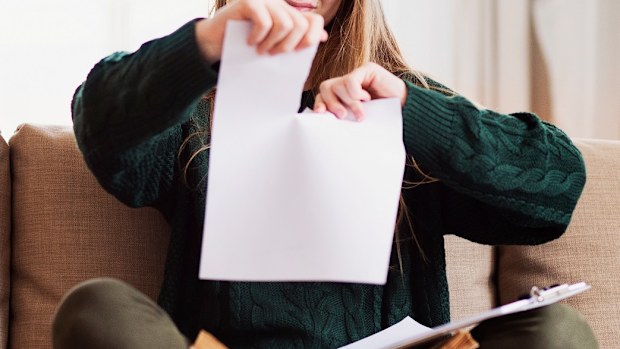 Woman tearing up piece of paper